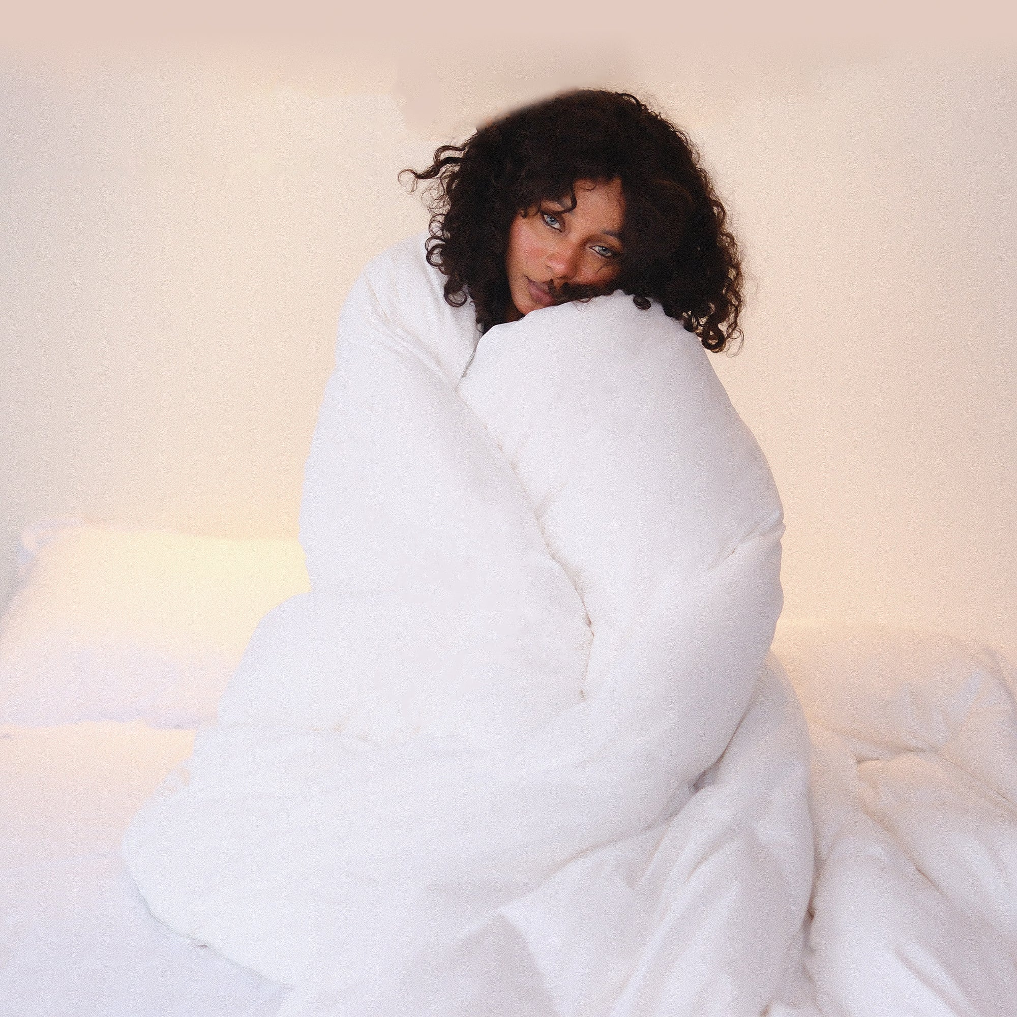 Wrapped in an APSMILE style white duvet, women experience the warmth and comfort of the product.