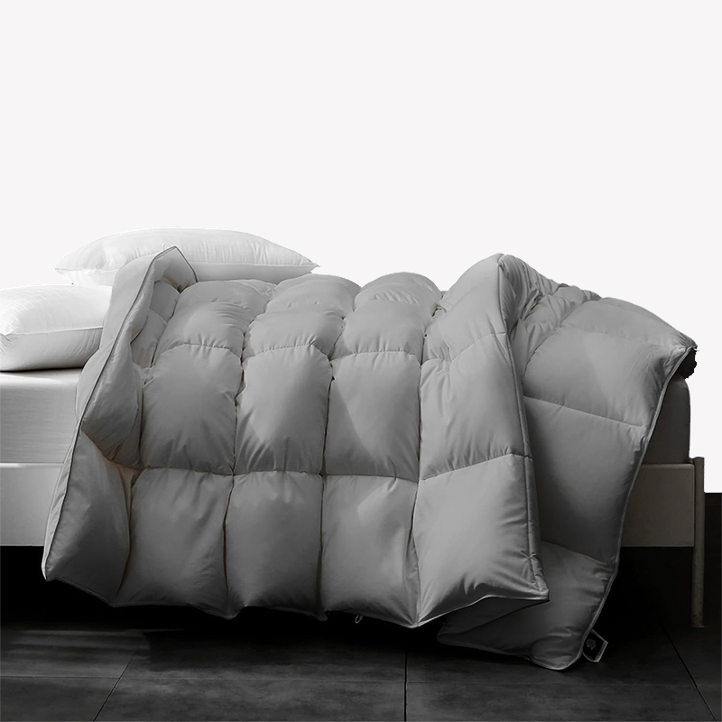 APSMILE light-gray square-stitched down comforter draped on a bed with white pillows.