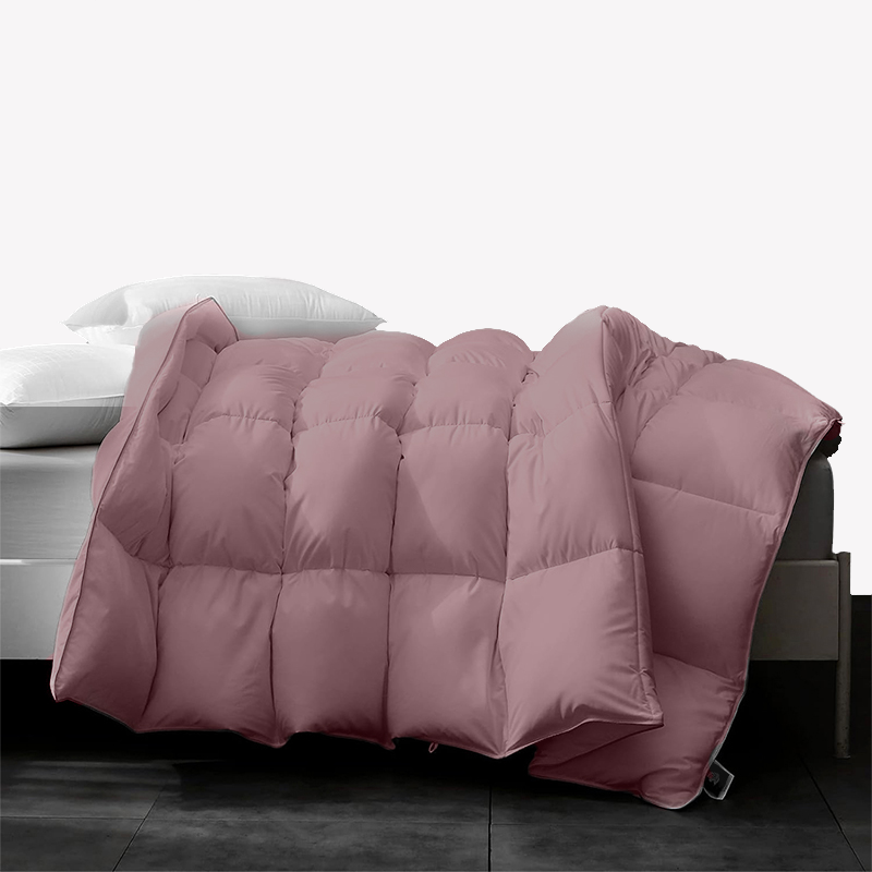 APSMILE down comforter in pink color, displayed on a bed with white pillows.