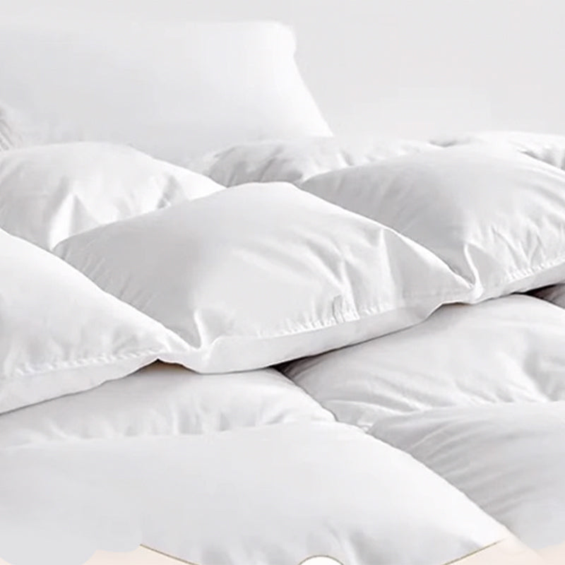 Close up of a white APSMILE down comforter with a baffle box construction.