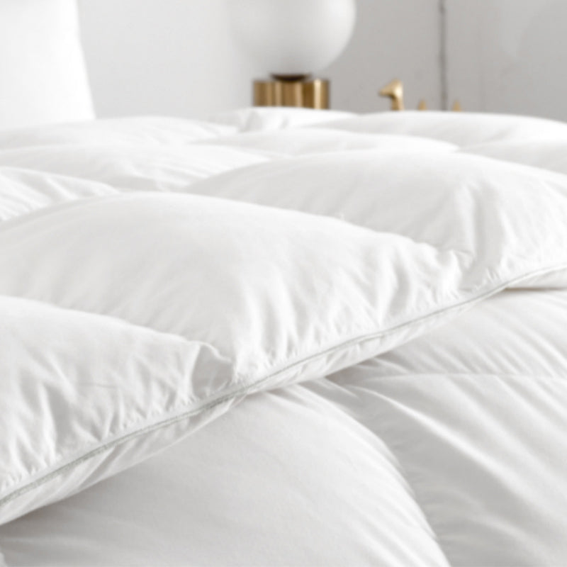 Close-up of a white down comforter with a baffle box construction.