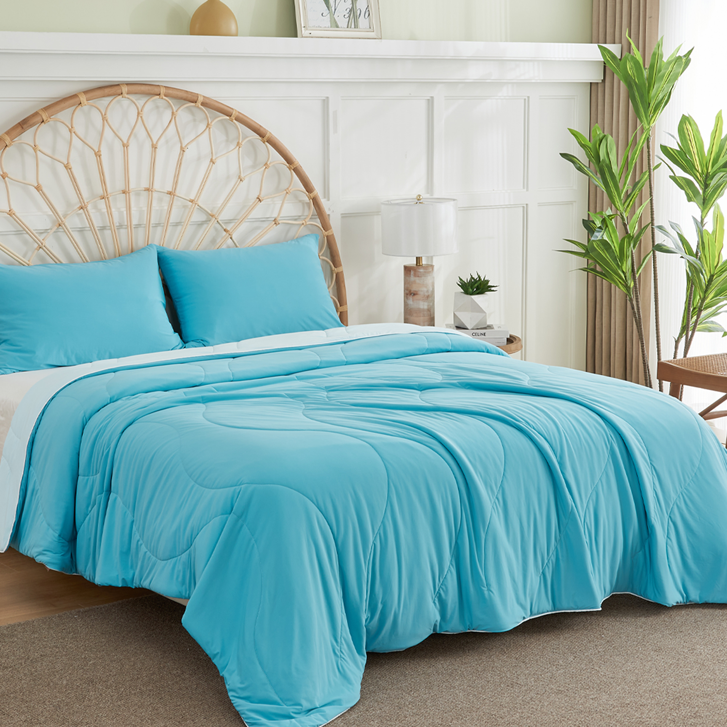 APSMILE azure cooling blanket, placed on a bed with a wicker headboard in a room with white paneled walls, a houseplant, and a bedside table with a lamp.