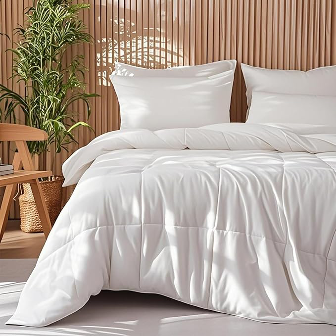 Close-up of an APSMILE bamboo fiber comforter with pillows on a bed against a slatted wood wall.