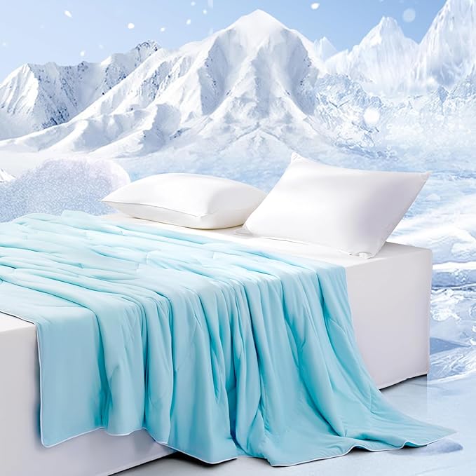 APSMILE cooling blanket in light blue on a white bed with two pillows against a snowy mountain background.