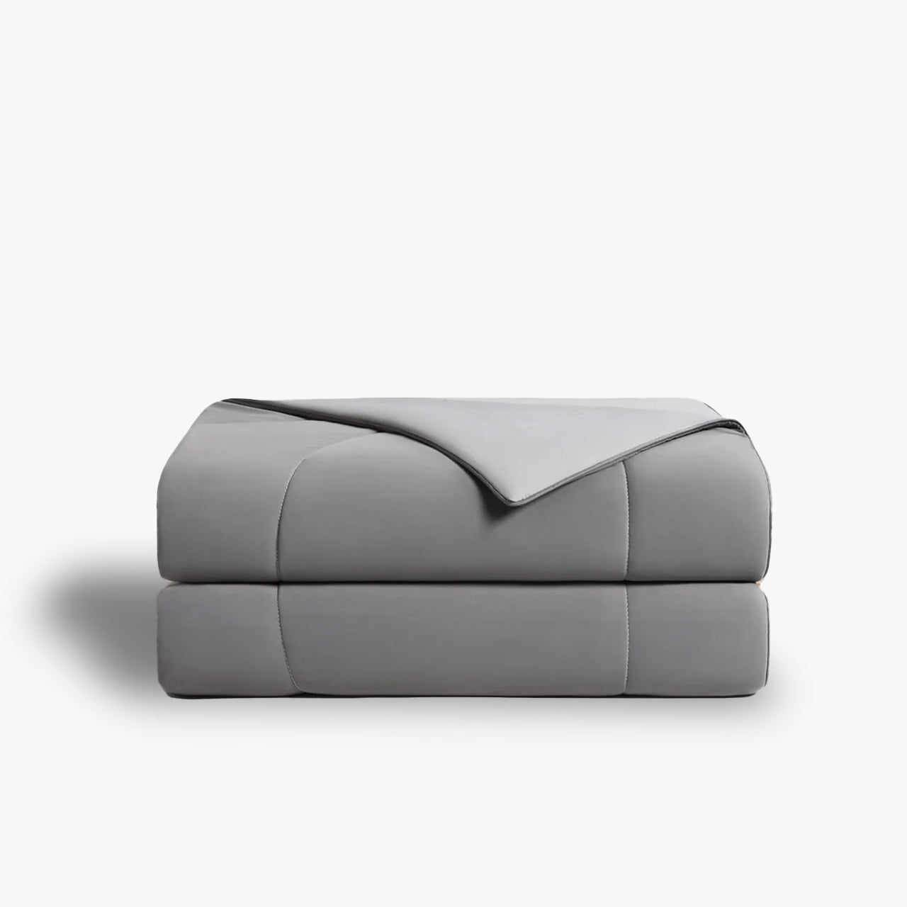 Folded gray comforter with light gray trim, presented on a white background.