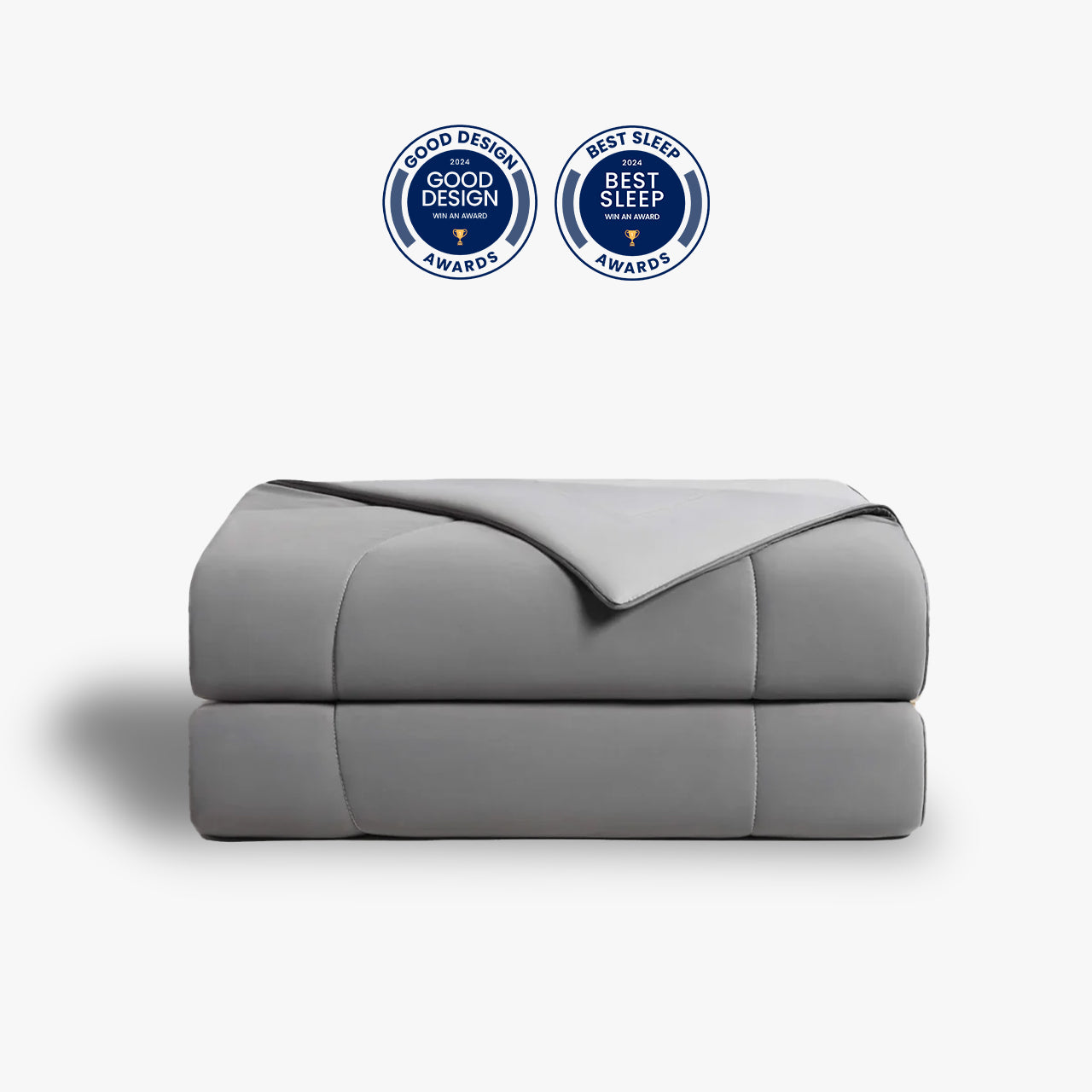 Light-gray APSMILE cooling blanket folded, with round awards seals for Good Design 2024 and Best Sleep 2024.
