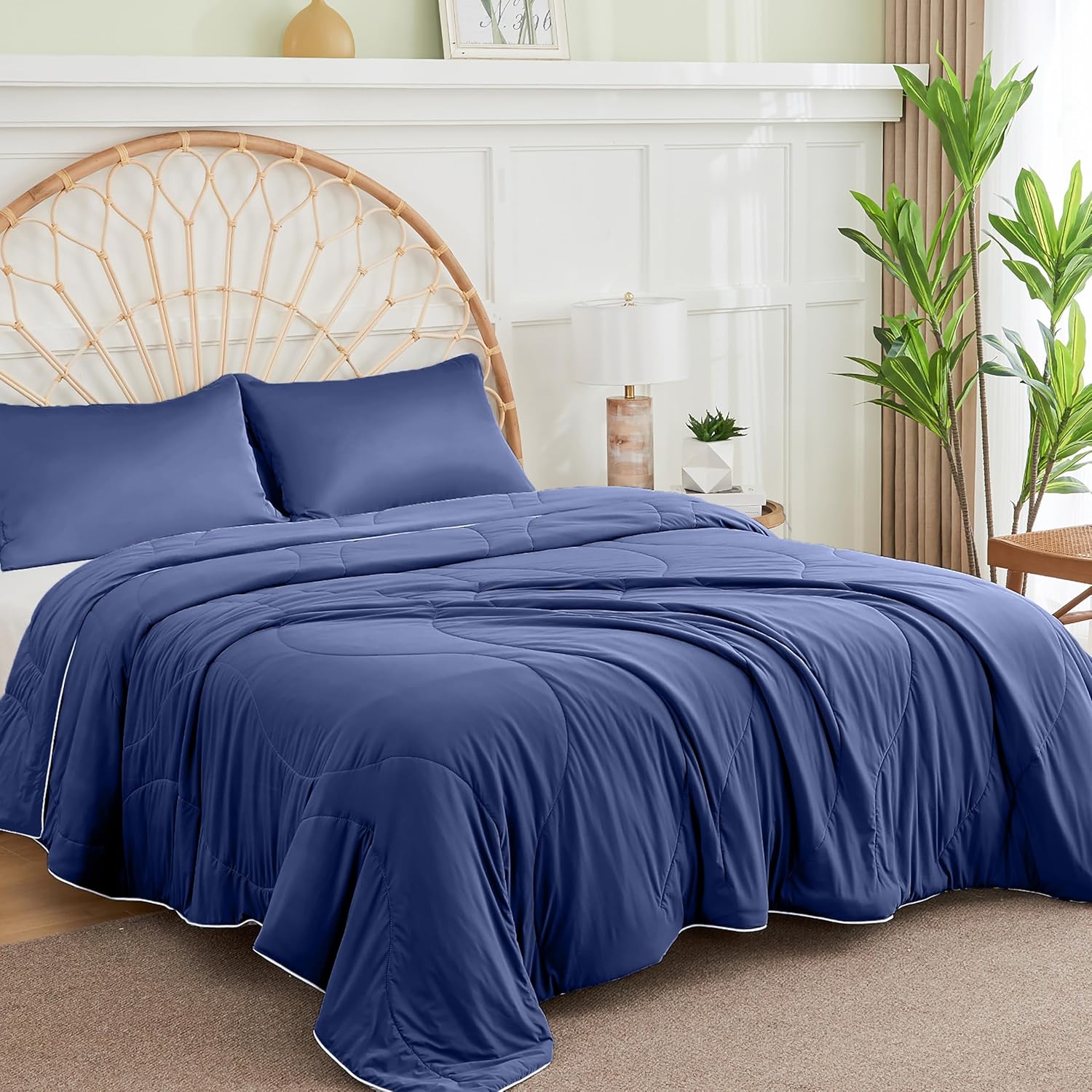 APSMILE cooling blanket, full size, in navy blue with white trim on a bed with a light wood headboard.